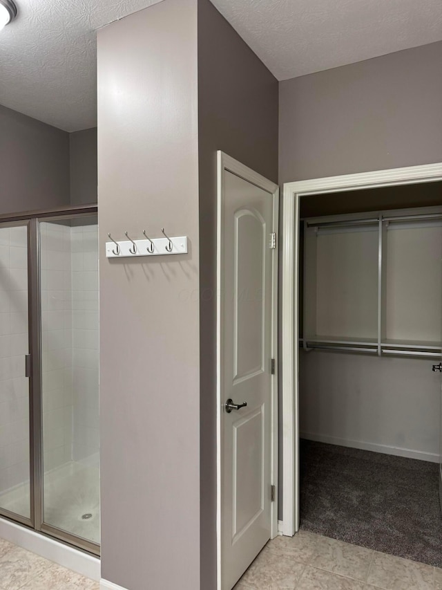 3757 Birkland Cir, Lewis Center, OH 43035 - bathroom featuring a stall shower and a textured ceiling