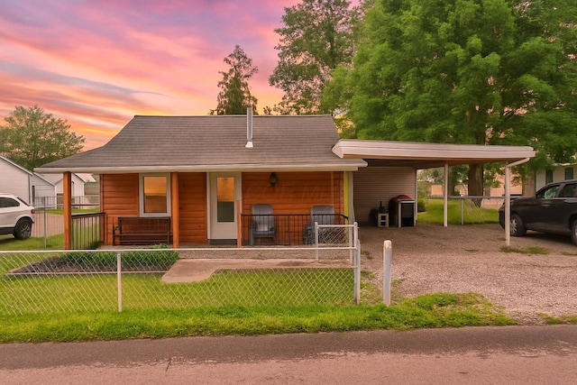 169 Myers Ave, Buckeye Lake, OH 43008 - view of front of home with a fenced front yard, a carport, a porch, and driveway