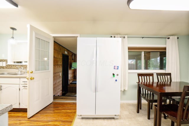 169 Myers Ave, Buckeye Lake, OH 43008 - kitchen featuring freestanding refrigerator, light wood-style flooring, light countertops, and white cabinetry