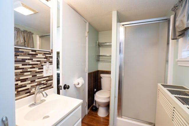 169 Myers Ave, Buckeye Lake, OH 43008 - bathroom featuring a stall shower, decorative backsplash, wood finished floors, and vanity