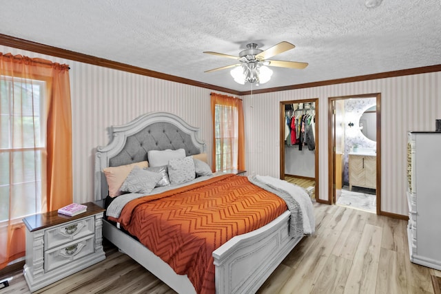 168 Thornapple Trl, Delaware, OH 43015 - bedroom with ornamental molding, light wood-style floors, a textured ceiling, ceiling fan, and wallpapered walls