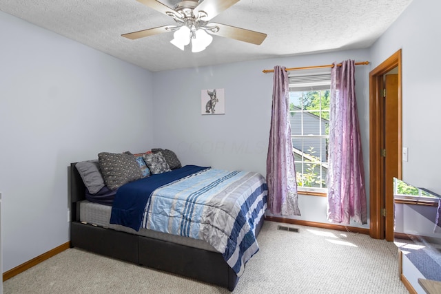 168 Thornapple Trl, Delaware, OH 43015 - bedroom with a textured ceiling, carpet floors, and ceiling fan