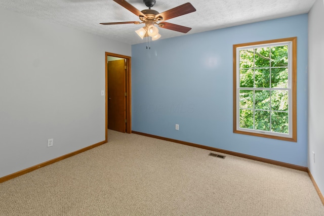 168 Thornapple Trl, Delaware, OH 43015 - spare room with carpet, a textured ceiling, and a ceiling fan
