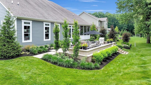 3017 Highland Woods Blvd, New Albany, OH 43054 - back of house with a sunroom, a lawn, outdoor dining space, a shingled roof, and a wooden deck