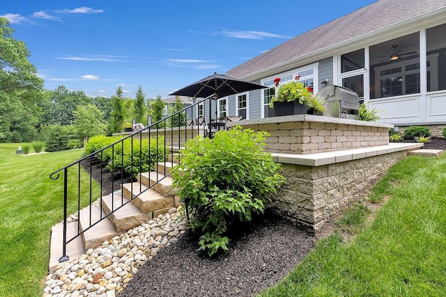 3017 Highland Woods Blvd, New Albany, OH 43054 - view of green lawn with stairway, a ceiling fan, and a sunroom