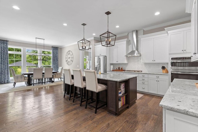 3017 Highland Woods Blvd, New Albany, OH 43054 - kitchen with wall chimney range hood, appliances with stainless steel finishes, ornamental molding, decorative backsplash, and white cabinetry
