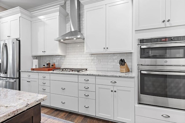 3017 Highland Woods Blvd, New Albany, OH 43054 - kitchen featuring appliances with stainless steel finishes, wall chimney exhaust hood, white cabinets, decorative backsplash, and dark wood-style flooring