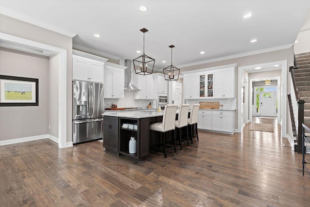3017 Highland Woods Blvd, New Albany, OH 43054 - kitchen featuring stainless steel appliances, wall chimney range hood, tasteful backsplash, white cabinets, and recessed lighting