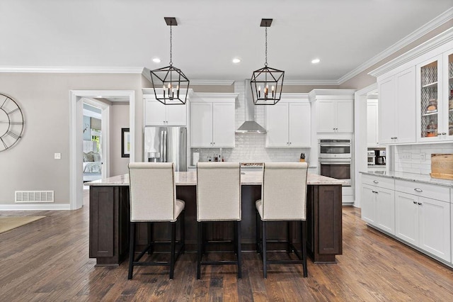 3017 Highland Woods Blvd, New Albany, OH 43054 - kitchen featuring stainless steel appliances, wall chimney exhaust hood, ornamental molding, a kitchen island with sink, and tasteful backsplash