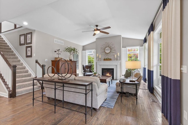 3017 Highland Woods Blvd, New Albany, OH 43054 - living room featuring a ceiling fan, hardwood / wood-style flooring, a brick fireplace, vaulted ceiling, and stairs