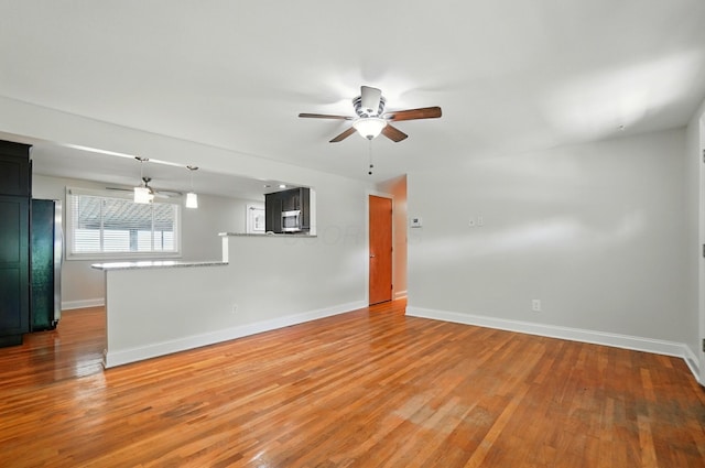 1574 River Bend Rd, Columbus, OH 43223 - unfurnished living room with a ceiling fan and light wood finished floors