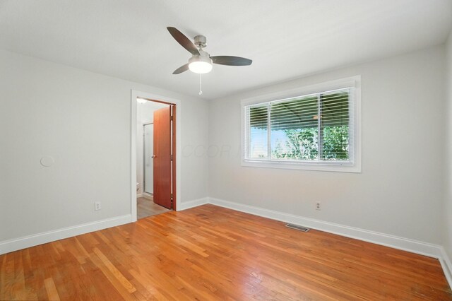 1574 River Bend Rd, Columbus, OH 43223 - unfurnished bedroom featuring light wood-type flooring, ceiling fan, and connected bathroom