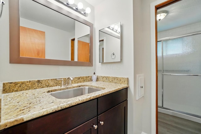 1574 River Bend Rd, Columbus, OH 43223 - full bathroom with vanity, a stall shower, and wood finished floors