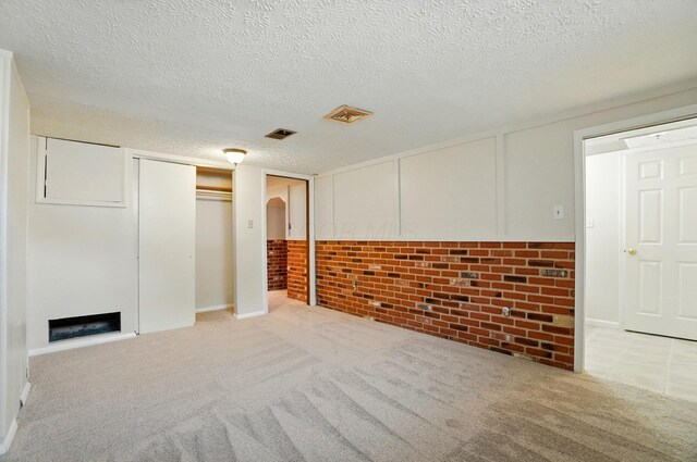 1574 River Bend Rd, Columbus, OH 43223 - finished basement featuring a textured ceiling, a fireplace, and carpet floors