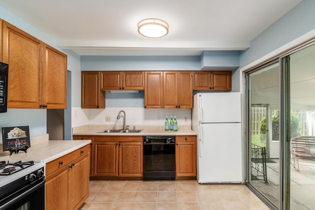 1276 Bryson Rd, Columbus, OH 43224 - kitchen with black appliances, brown cabinetry, light countertops, and decorative backsplash