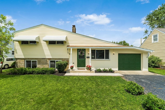 1276 Bryson Rd, Columbus, OH 43224 - split level home with a garage, driveway, a front yard, and a chimney