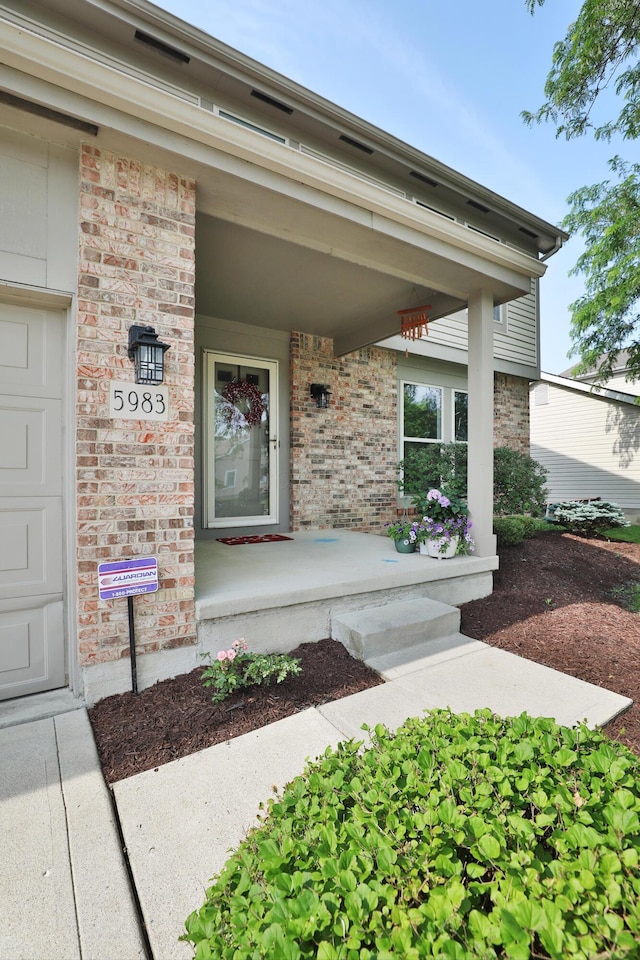 5983 Epernay Way, Galloway, OH 43119 - doorway to property with covered porch and brick siding