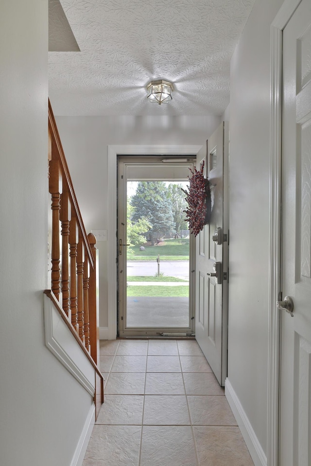 5983 Epernay Way, Galloway, OH 43119 - entryway featuring a textured ceiling, stairs, and light tile patterned floors