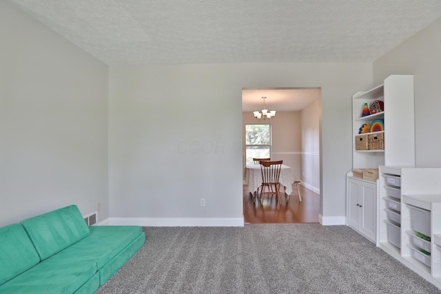 5983 Epernay Way, Galloway, OH 43119 - living area featuring carpet flooring, a chandelier, and a textured ceiling