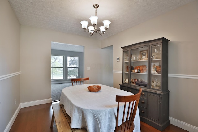 5983 Epernay Way, Galloway, OH 43119 - dining area with a chandelier, dark wood finished floors, and a textured ceiling
