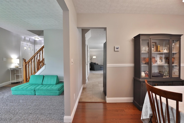 5983 Epernay Way, Galloway, OH 43119 - hallway featuring a textured ceiling, stairs, and wood finished floors