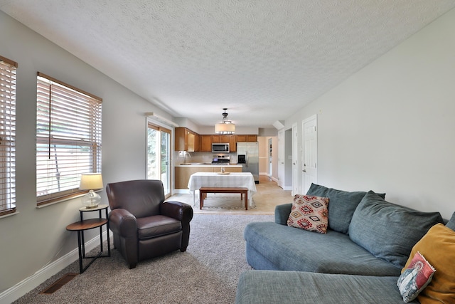 5983 Epernay Way, Galloway, OH 43119 - living area featuring light colored carpet and a textured ceiling