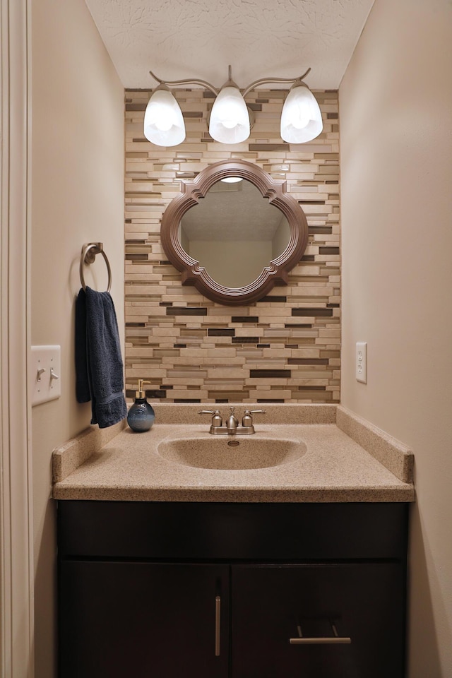 5983 Epernay Way, Galloway, OH 43119 - bathroom featuring vanity, tasteful backsplash, and a textured ceiling