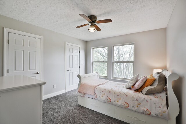 5983 Epernay Way, Galloway, OH 43119 - bedroom featuring dark carpet, a textured ceiling, and a ceiling fan