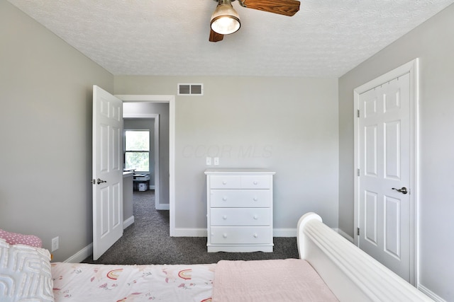5983 Epernay Way, Galloway, OH 43119 - bedroom with dark colored carpet, a textured ceiling, and ceiling fan