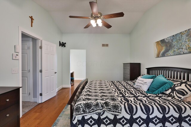5983 Epernay Way, Galloway, OH 43119 - bedroom with vaulted ceiling, wood finished floors, and a ceiling fan