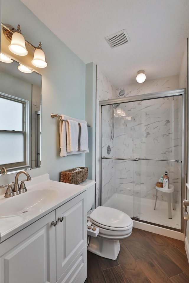 5983 Epernay Way, Galloway, OH 43119 - bathroom with vanity, a marble finish shower, and wood finished floors