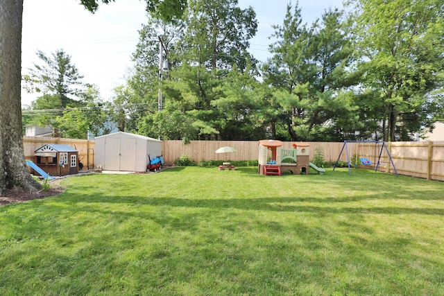 5983 Epernay Way, Galloway, OH 43119 - fenced backyard featuring a storage unit and a playground