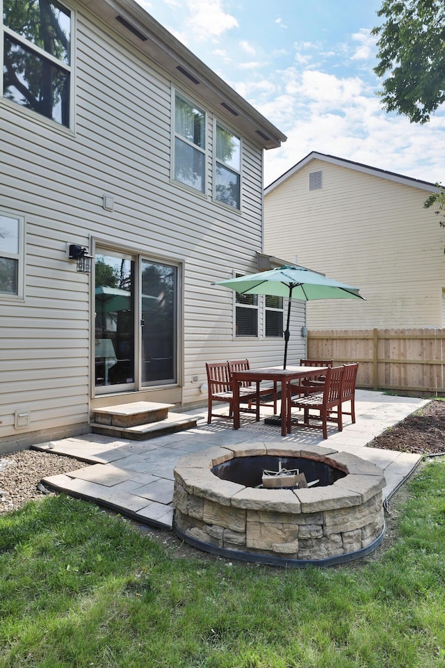 5983 Epernay Way, Galloway, OH 43119 - rear view of property featuring a fire pit and a patio area
