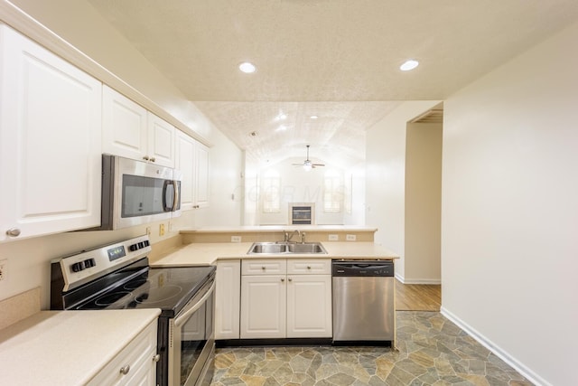 147 Shadymere Ln, Columbus, OH 43213 - kitchen featuring appliances with stainless steel finishes, a peninsula, lofted ceiling, a ceiling fan, and recessed lighting