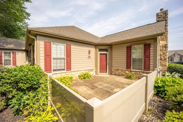 147 Shadymere Ln, Columbus, OH 43213 - view of front of home featuring stone siding, a chimney, and a shingled roof
