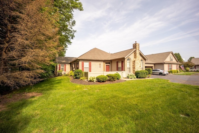 147 Shadymere Ln, Columbus, OH 43213 - single story home featuring a chimney, driveway, a front yard, and an attached garage
