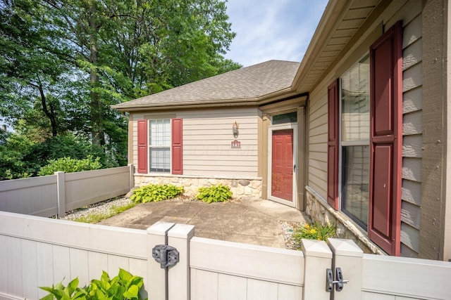 147 Shadymere Ln, Columbus, OH 43213 - doorway to property with stone siding, a gate, and roof with shingles