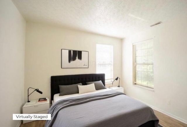 147 Shadymere Ln, Columbus, OH 43213 - bedroom featuring a textured ceiling and wood finished floors