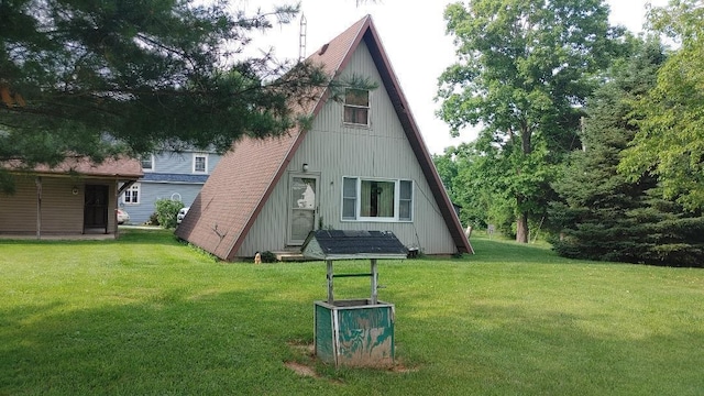 103 Center St, Waldo, OH 43356 - rear view of house featuring a lawn