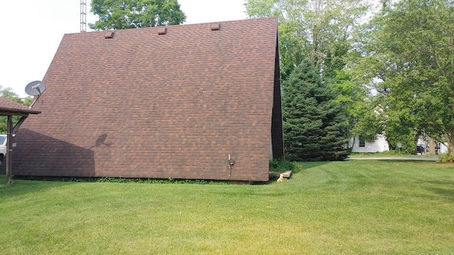103 Center St, Waldo, OH 43356 - view of home's exterior with a yard and a shingled roof