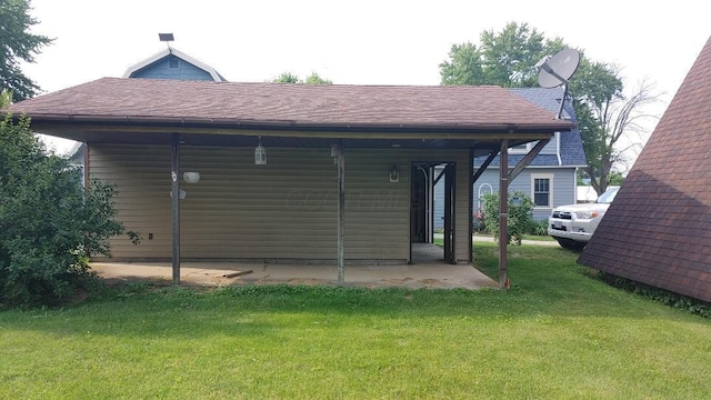 103 Center St, Waldo, OH 43356 - back of house featuring a lawn and a shingled roof