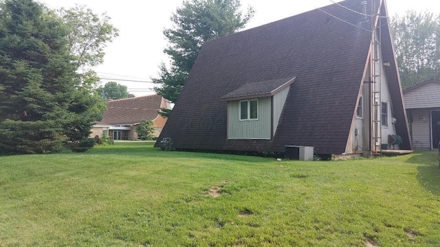 103 Center St, Waldo, OH 43356 - view of home's exterior with a lawn and roof with shingles