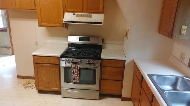 103 Center St, Waldo, OH 43356 - kitchen featuring stainless steel range with gas cooktop, extractor fan, and brown cabinetry