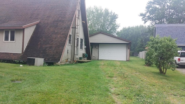 103 Center St, Waldo, OH 43356 - view of side of home featuring a yard, roof with shingles, a garage, an outdoor structure, and driveway