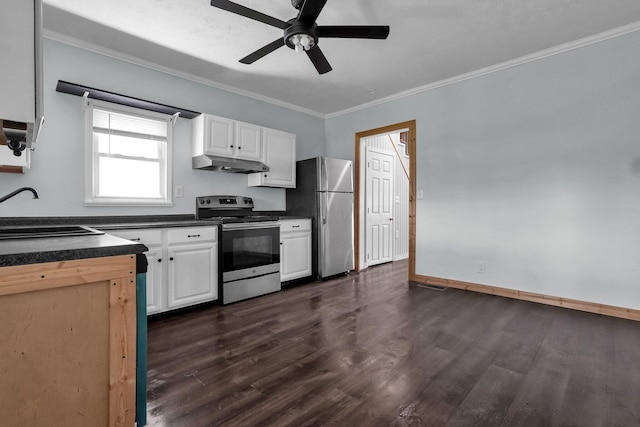 212 S Pickaway St, Circleville, OH 43113 - kitchen featuring stainless steel appliances, under cabinet range hood, dark countertops, crown molding, and dark wood-style flooring