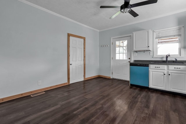 212 S Pickaway St, Circleville, OH 43113 - kitchen with dishwashing machine, dark wood-style flooring, dark countertops, ceiling fan, and white cabinetry