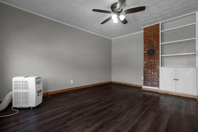 212 S Pickaway St, Circleville, OH 43113 - empty room with ceiling fan, dark wood-type flooring, a textured ceiling, crown molding, and built in shelves