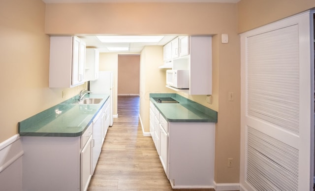 83 Tarryton Ct W, Columbus, OH 43228 - kitchen with white microwave, light wood-style flooring, white cabinets, and a drop ceiling