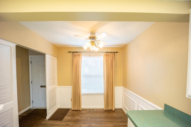 83 Tarryton Ct W, Columbus, OH 43228 - unfurnished dining area with a wainscoted wall, dark wood finished floors, and ceiling fan