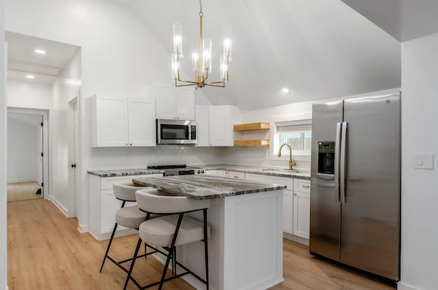 165 W Jersey St, Johnstown, OH 43031 - kitchen with appliances with stainless steel finishes, backsplash, a chandelier, white cabinetry, and high vaulted ceiling